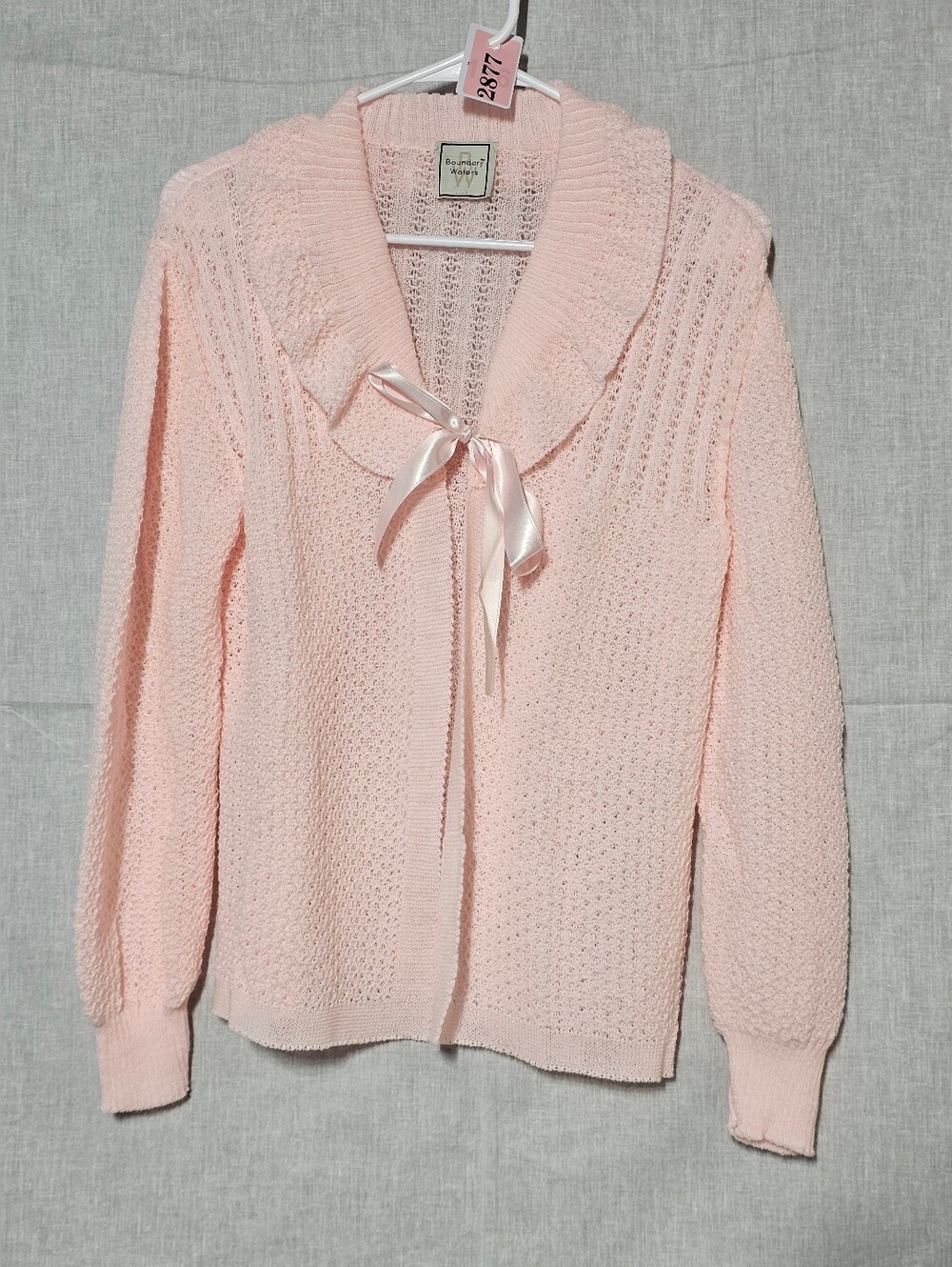 Vintage-Inspired Pink Knit Sweater with Ribbon Tie